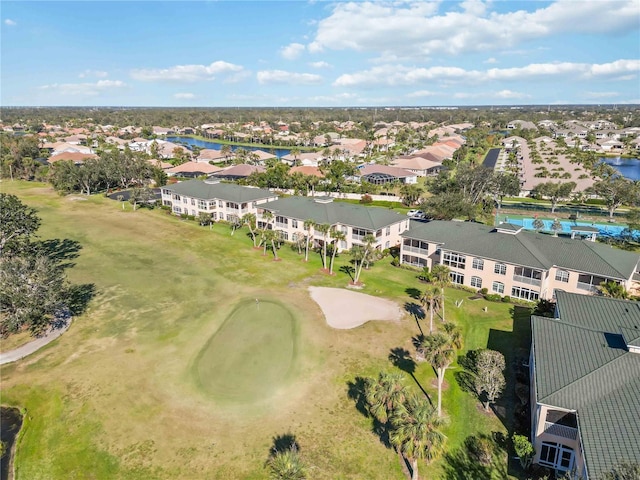 birds eye view of property featuring view of golf course, a residential view, and a water view