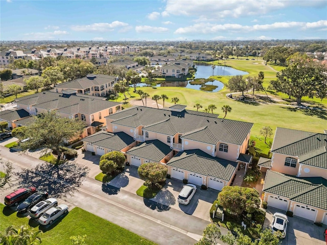 aerial view featuring golf course view, a residential view, and a water view