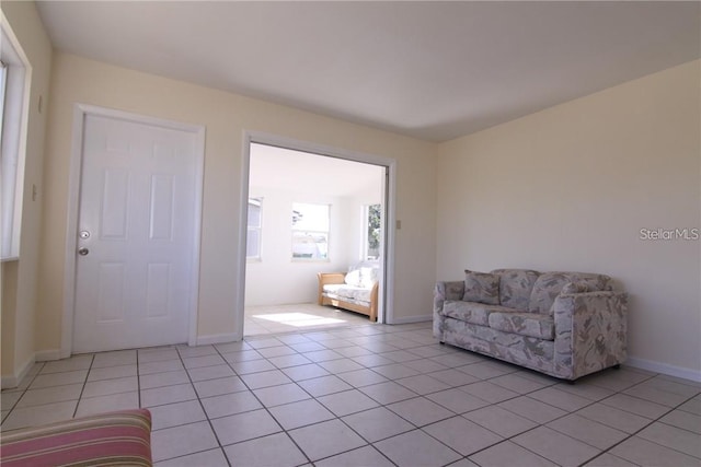 sitting room with light tile patterned floors and baseboards