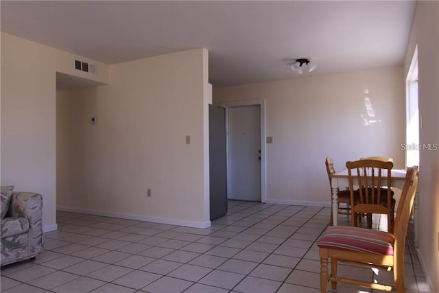 interior space with visible vents, baseboards, and light tile patterned floors