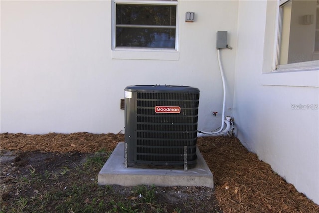 exterior details featuring central AC and stucco siding