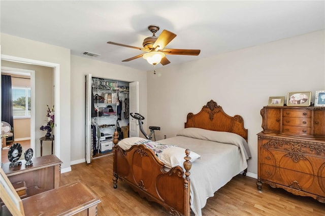 bedroom with light wood-style floors, visible vents, a closet, and baseboards