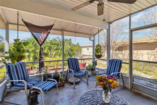 sunroom / solarium with a ceiling fan