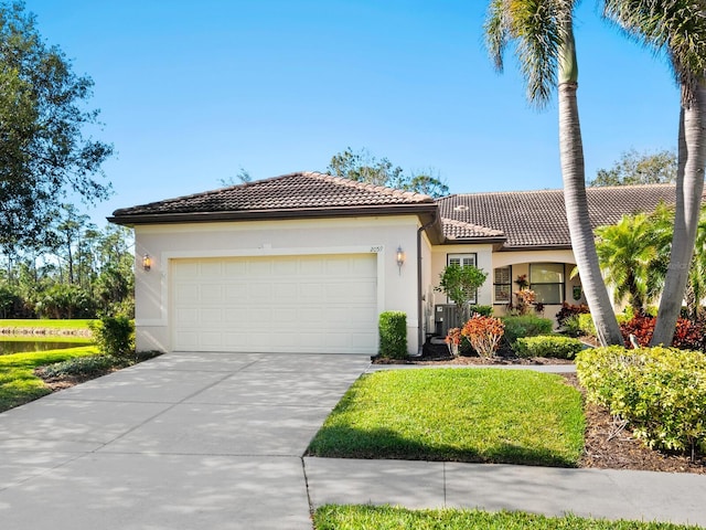 view of front of property featuring a garage, a tile roof, concrete driveway, and stucco siding