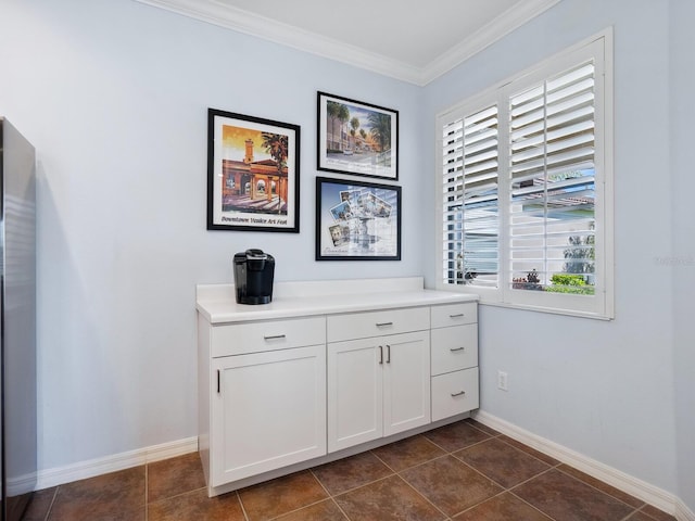 interior space with crown molding and baseboards