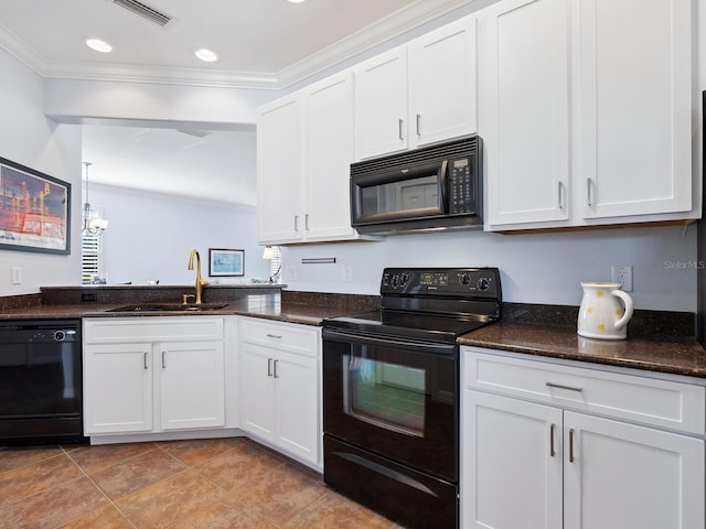 kitchen with visible vents, crown molding, black appliances, white cabinetry, and a sink