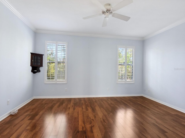 empty room featuring baseboards, dark wood-style flooring, and a wealth of natural light