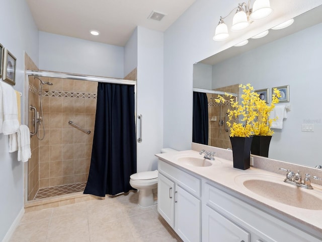 full bath featuring a stall shower, visible vents, a sink, and double vanity