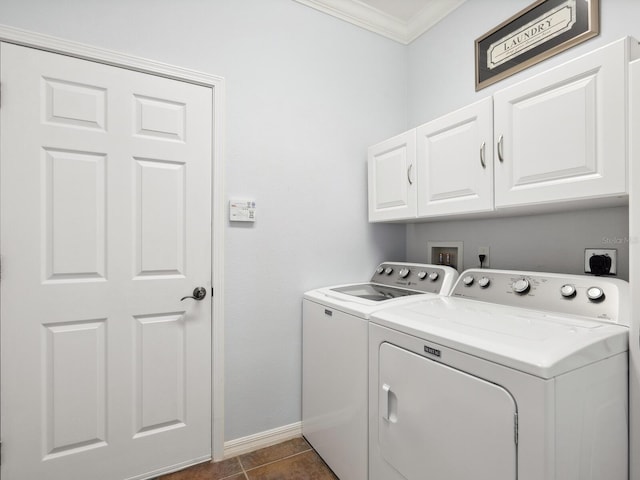 washroom with crown molding, cabinet space, independent washer and dryer, dark tile patterned floors, and baseboards