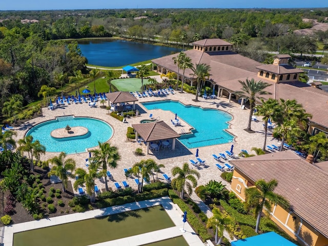 drone / aerial view featuring a water view and a view of trees