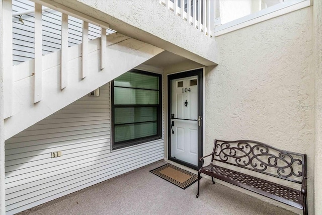 property entrance featuring stucco siding