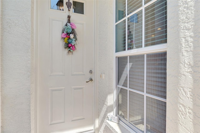 entrance to property with stucco siding