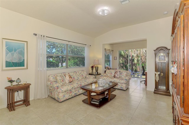 living room featuring lofted ceiling and light tile patterned floors