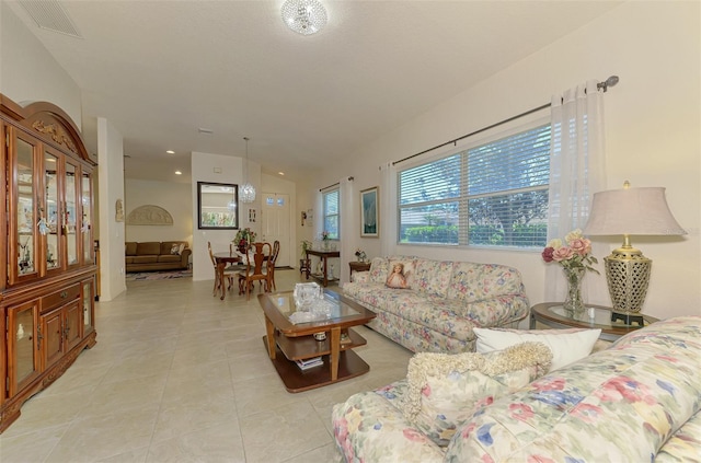 living room with light tile patterned floors and visible vents