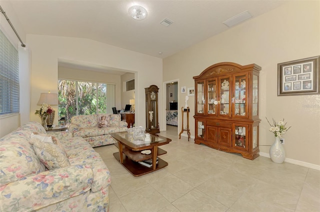 living room featuring light tile patterned floors, visible vents, and baseboards