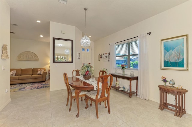 dining room with lofted ceiling, light tile patterned floors, recessed lighting, baseboards, and an inviting chandelier