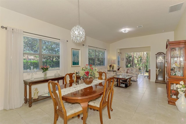 dining room featuring lofted ceiling, an inviting chandelier, visible vents, and light tile patterned flooring