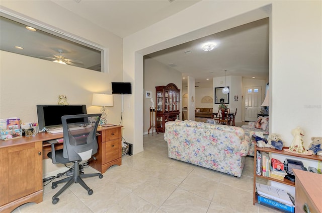 office area with light tile patterned floors and ceiling fan