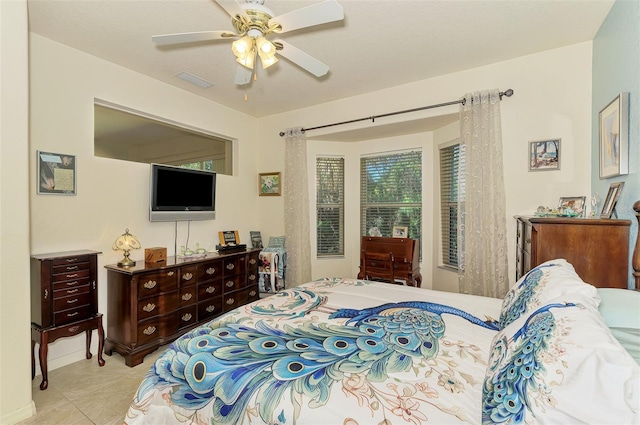 bedroom with tile patterned flooring, visible vents, and a ceiling fan