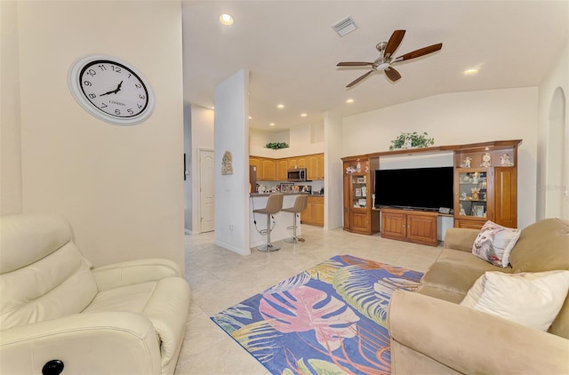 living room featuring light tile patterned floors, ceiling fan, visible vents, and recessed lighting