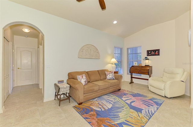 living room with lofted ceiling, light tile patterned flooring, arched walkways, and a ceiling fan