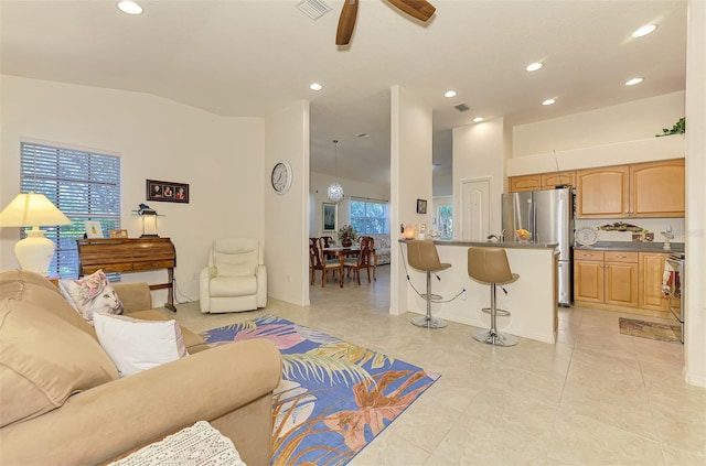 living room with lofted ceiling, ceiling fan, visible vents, and recessed lighting