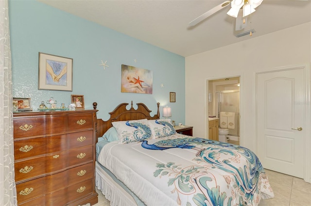 bedroom with ceiling fan, light tile patterned flooring, and ensuite bath