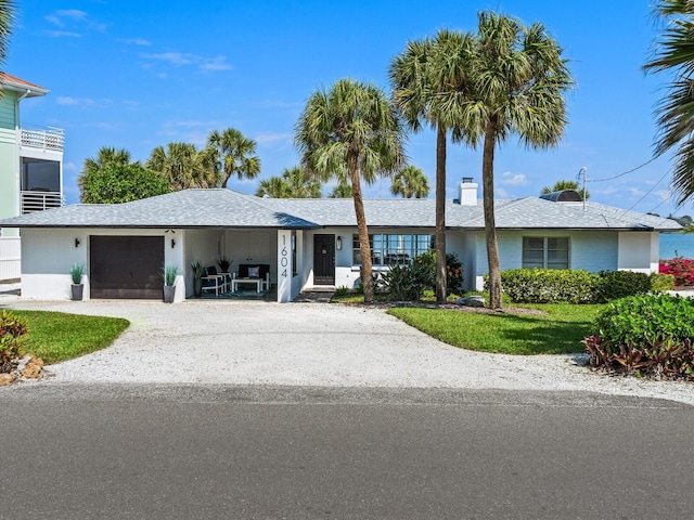 single story home with a garage and driveway