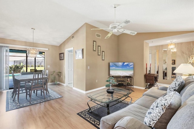 living room with baseboards, visible vents, vaulted ceiling, and light wood finished floors