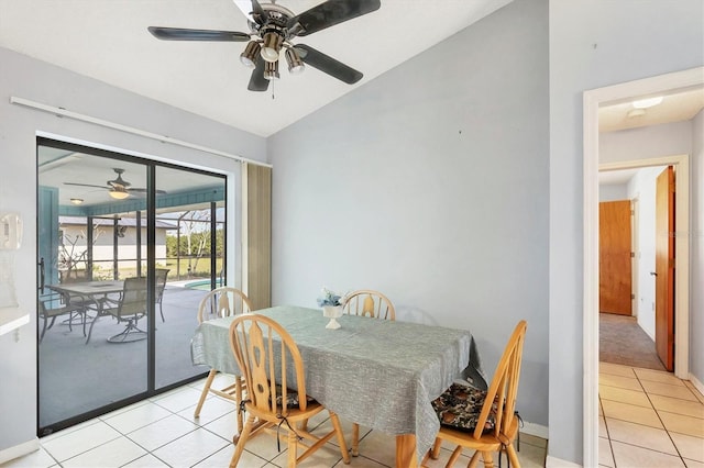 dining room featuring lofted ceiling, light tile patterned flooring, and a sunroom