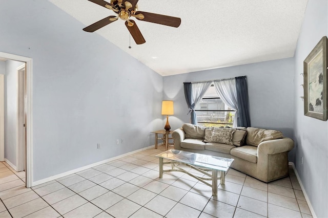 living room with light tile patterned floors, ceiling fan, vaulted ceiling, a textured ceiling, and baseboards