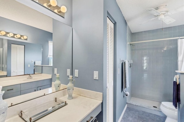 full bath featuring tile patterned floors, a tile shower, a closet, and vanity