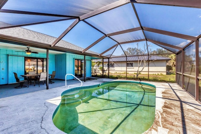 pool with glass enclosure and a patio