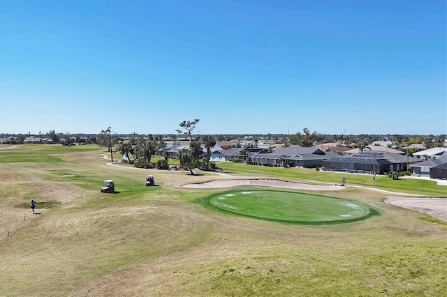 view of home's community with a residential view, golf course view, and a lawn