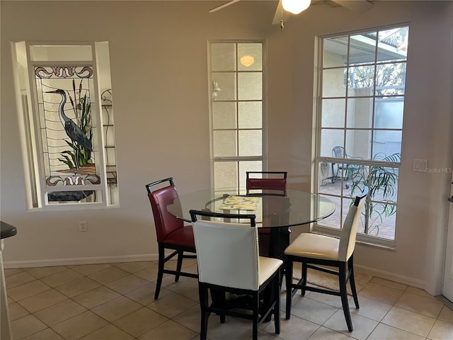 dining room with ceiling fan, baseboards, and tile patterned floors