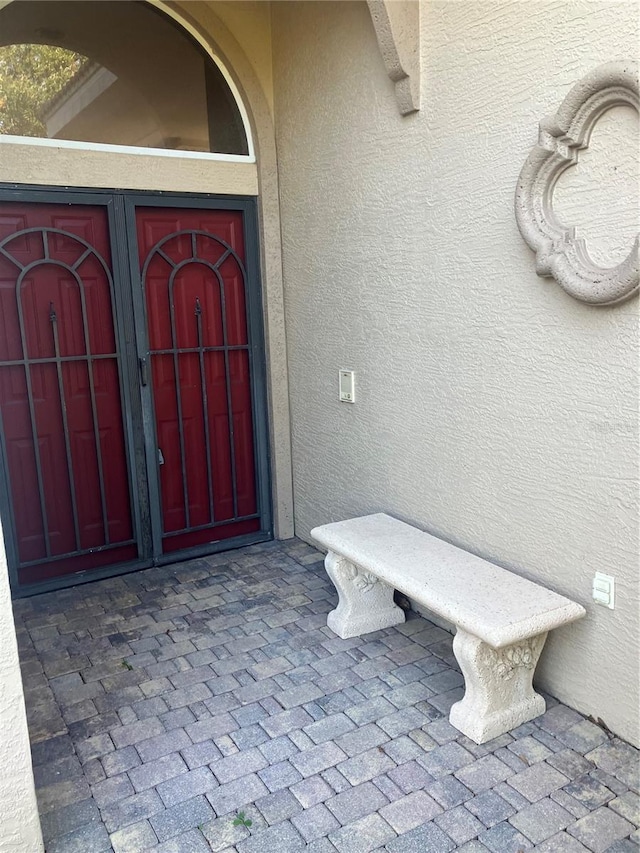 property entrance featuring stucco siding