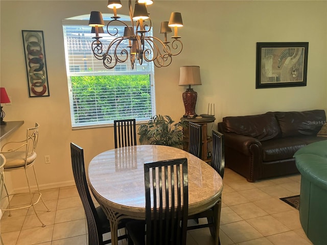 dining space featuring a notable chandelier, baseboards, and light tile patterned floors