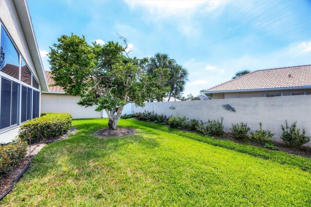 view of yard with a fenced backyard