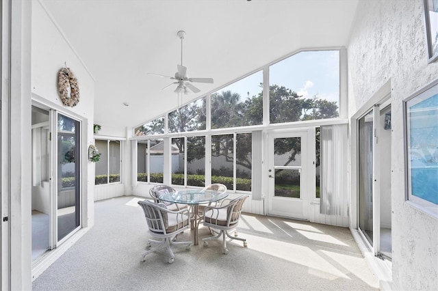 sunroom featuring a ceiling fan, a healthy amount of sunlight, and vaulted ceiling