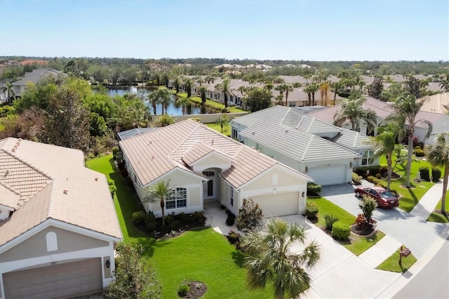 birds eye view of property with a water view and a residential view