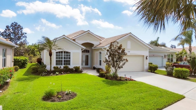 ranch-style house featuring a tile roof, stucco siding, an attached garage, driveway, and a front lawn