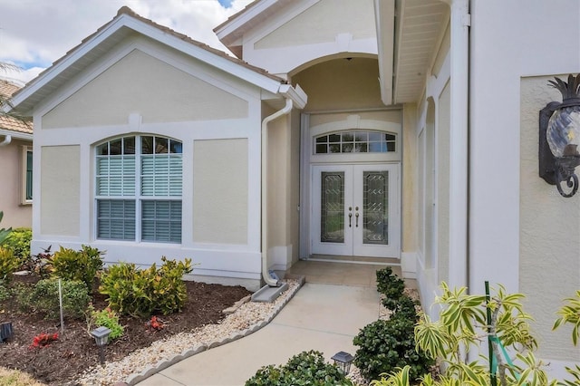 property entrance with french doors and stucco siding