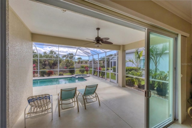 view of swimming pool with a ceiling fan, a pool with connected hot tub, a lanai, and a patio