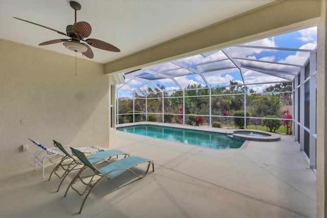 view of pool with a pool with connected hot tub, a lanai, a patio, and ceiling fan