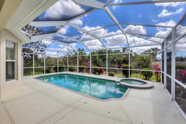 view of swimming pool featuring a pool with connected hot tub, a patio, and a lanai