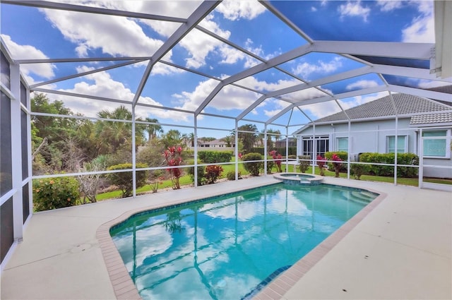 view of swimming pool featuring glass enclosure, a pool with connected hot tub, and a patio