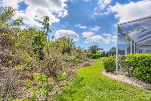 view of yard with glass enclosure