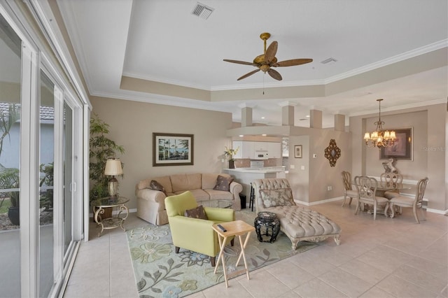 living room with light tile patterned floors, visible vents, a raised ceiling, and ornamental molding