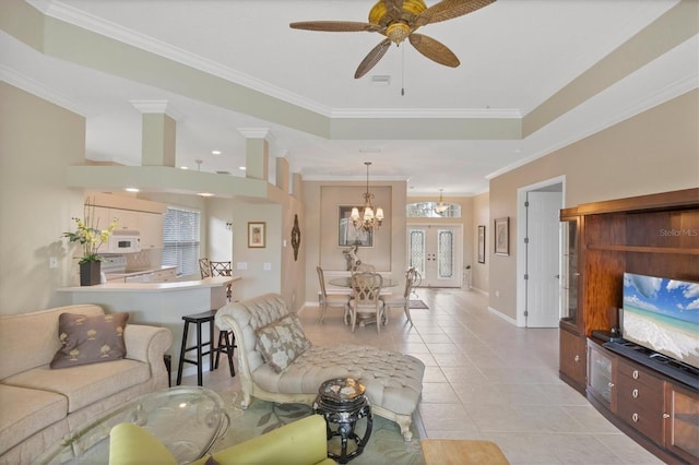 living area with light tile patterned flooring, visible vents, a healthy amount of sunlight, a raised ceiling, and crown molding