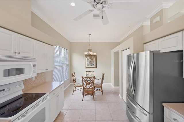 kitchen with light tile patterned floors, white appliances, white cabinetry, ornamental molding, and backsplash